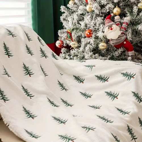 plaid de noël blanc sapin vert sur un fauteuil