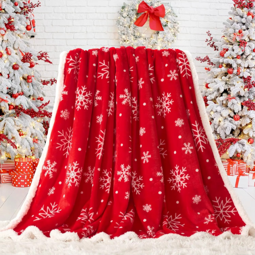 plaid de noël rouge flocon de neige sur un fauteuil